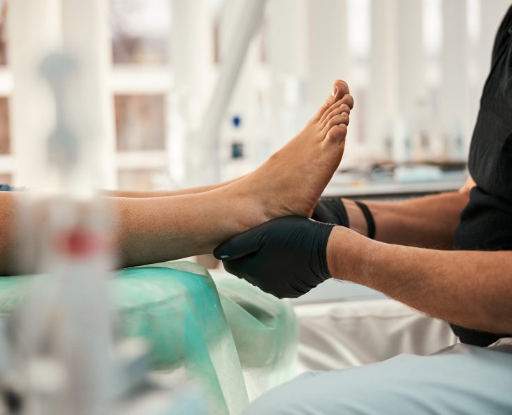 Close up of competent doctor doing foot massage