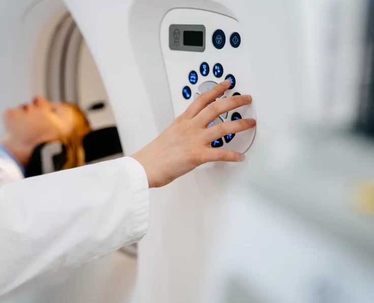 Medical professional operating advanced imaging machine for diagnosis