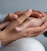 Close up young daughter comforting mature mother, granddaughter holding older grandmother hand, expressing love and support, good trusted family relationship, two generations, care to senior people